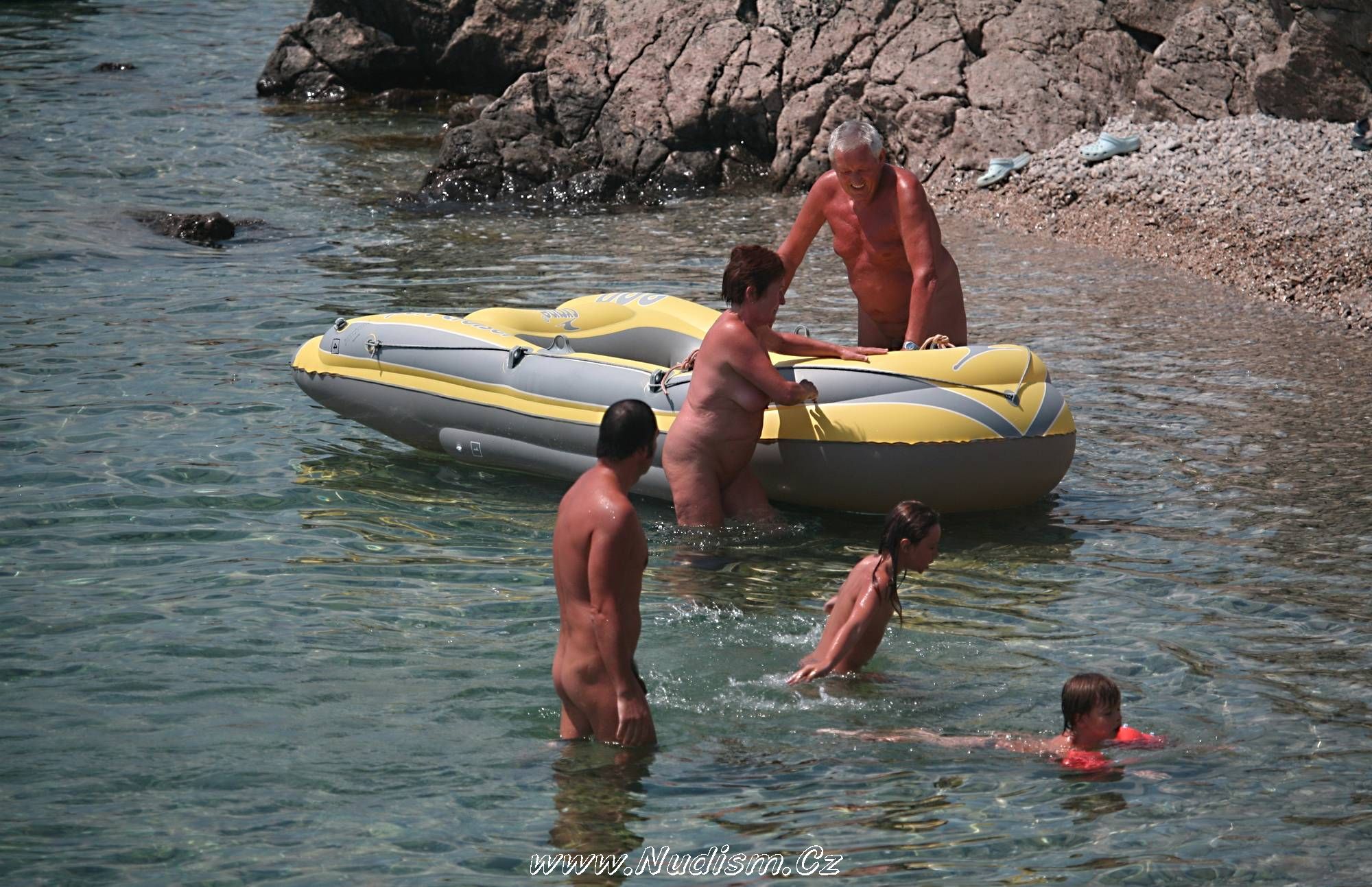 [Image: Pure-Nudism-Images-Lone-Nudist-in-Yellow-Boat-1.jpg]